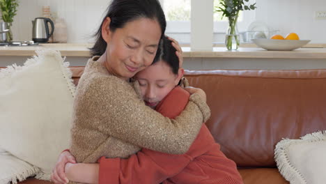 love, hug and mother and daughter on sofa