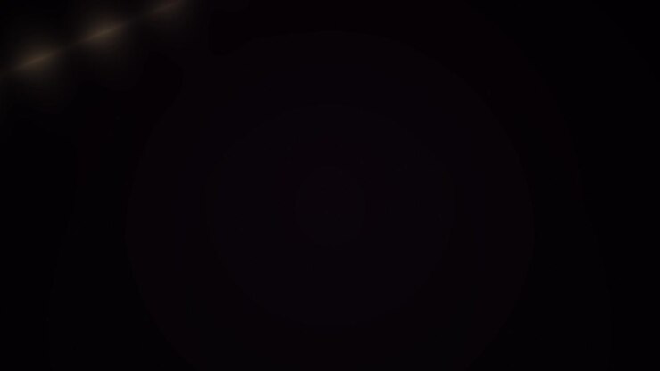 Subtle Dust Particles Floating with Golden Lens Flare on Black Background