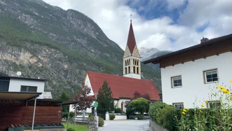 church in tyrol austria showing first snow on mountain behind