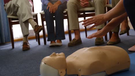 doctor performing resuscitation training on a dummy