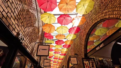 vibrant umbrellas hanging in camden market alley