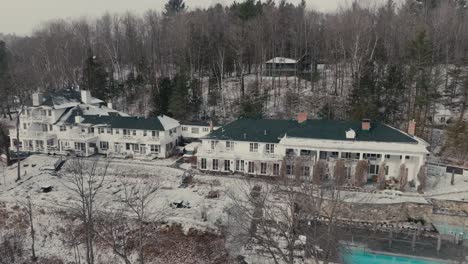 mansion of manoir hovey hotel during winter snowfall in north hatley, québec, canada