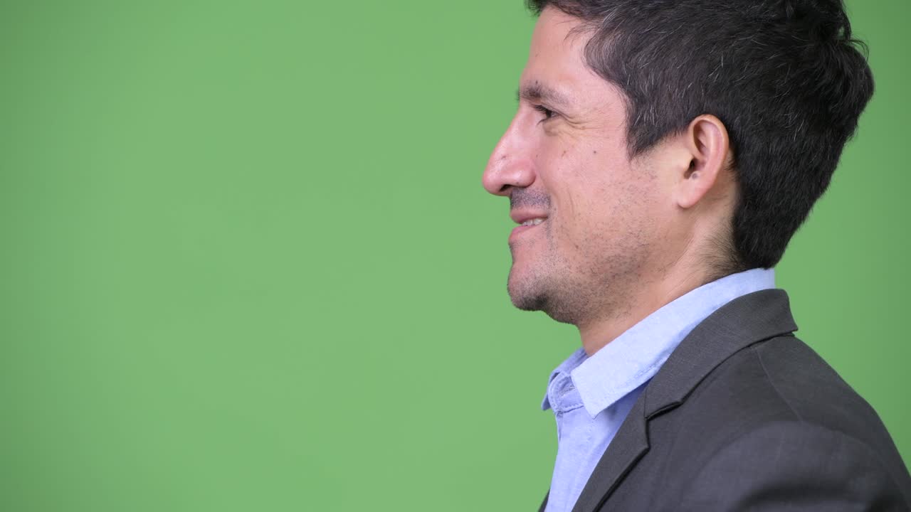 Headshot profile view of Hispanic businessman smiling