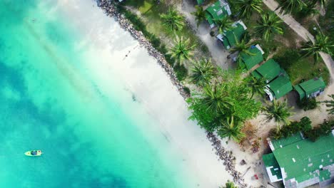 Strandbungalows-Am-Ufer-Einer-Tropischen-Insel-Mit-Weißem-Sand,-Umspült-Von-Einer-Ruhigen-Türkisfarbenen-Lagune-Und-Palmen-In-Malaysia