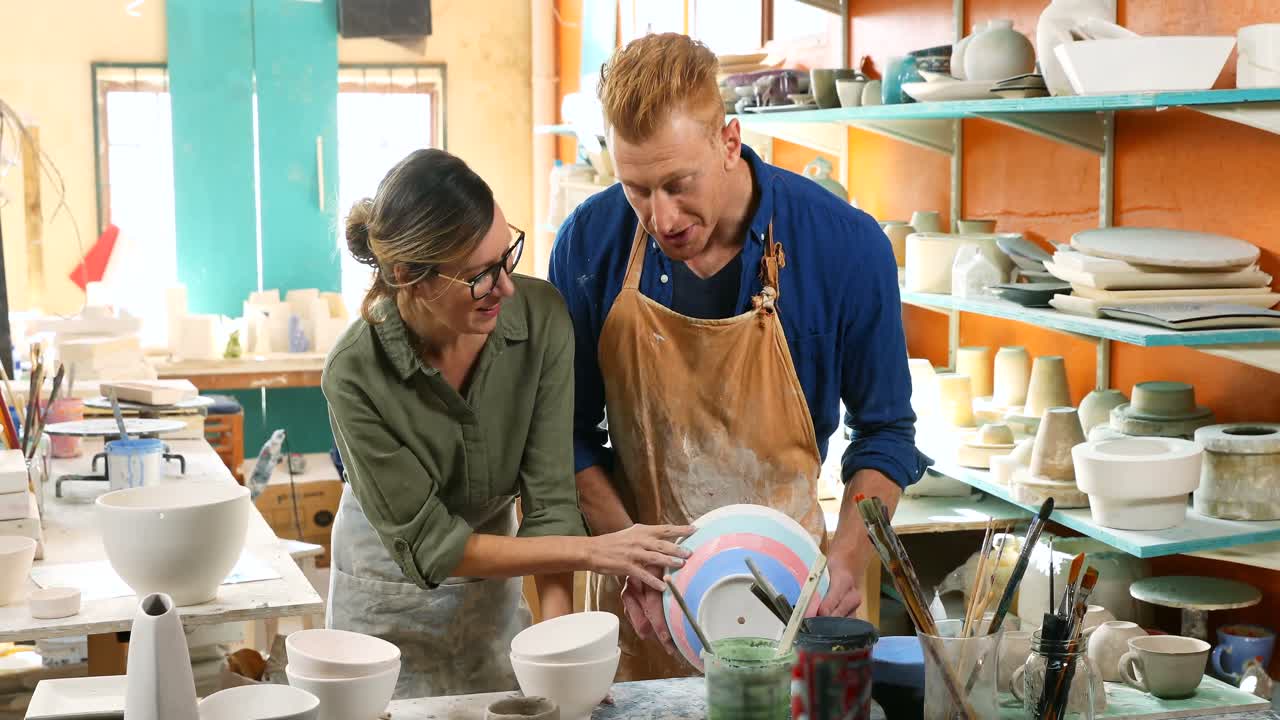 Male and female potter interacting with each other 4k