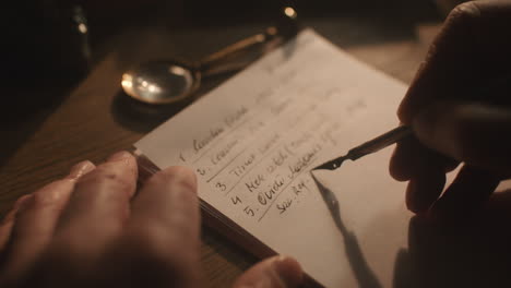 Old passionate man writes a letter in his office at night