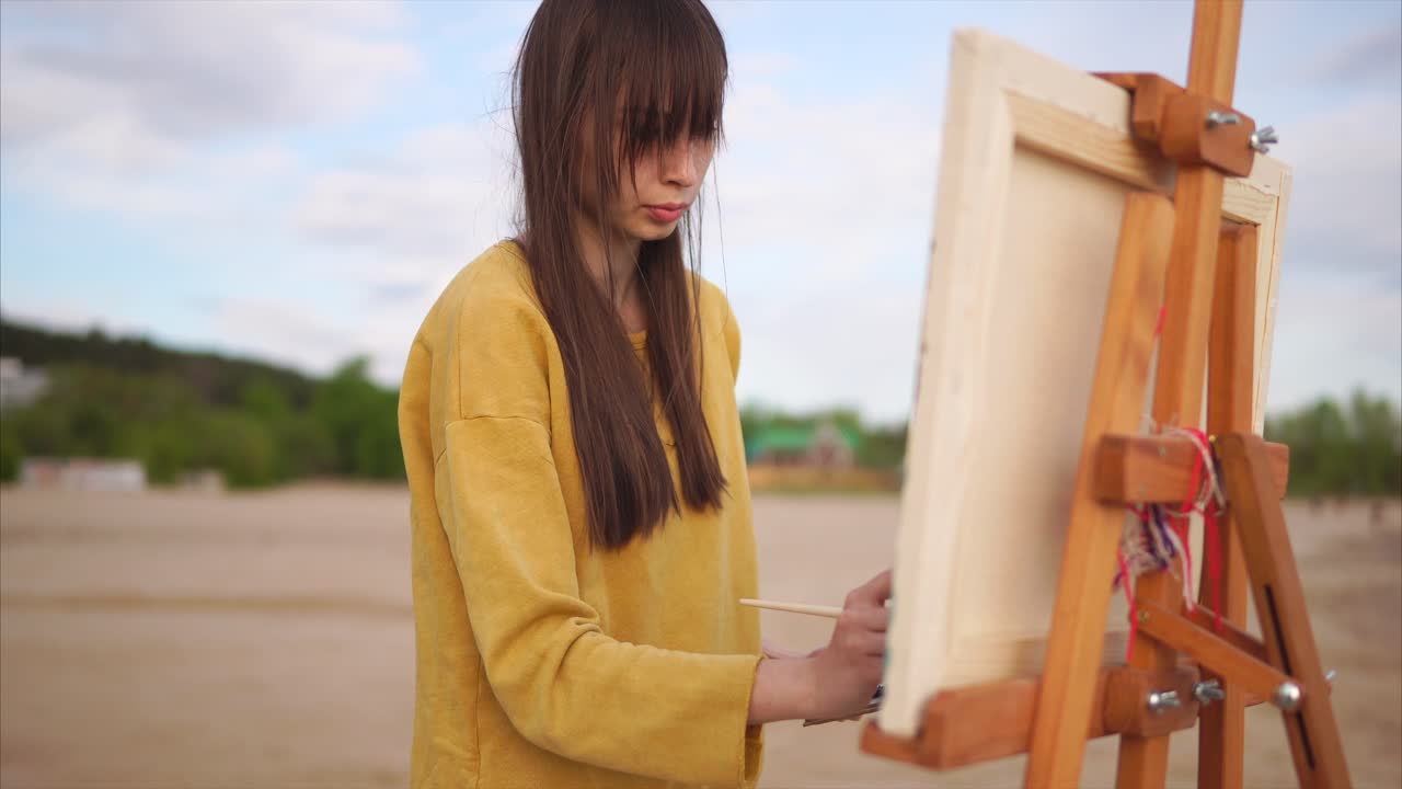 Woman Painting Outdoors on a Beach
