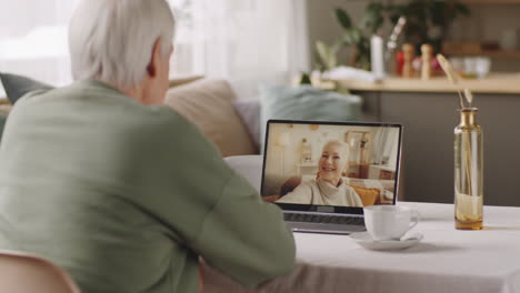 elderly man talking with female friend on online call