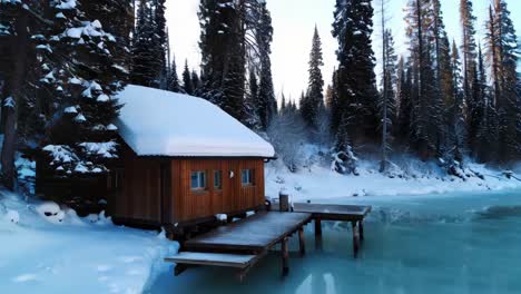 snowy cabin on frozen lake