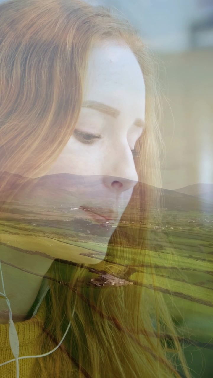 Vertical video: Woman with wired buds, practicing music while landscape overlay moving across frame