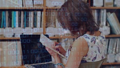 a young woman is studying in a library with a laptop at the university