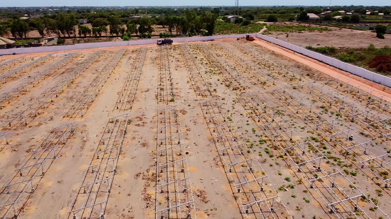Aerial pan shot of empty steel frames at a solar power park construction site
