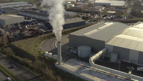 Drone-view-of-Industrial-chimney-and-major-road,-A12