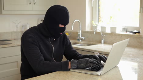 burglar hacking into laptop