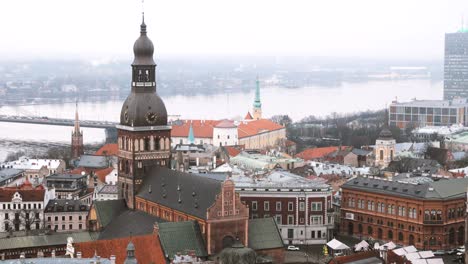 riga, latvia. top view of cityscape and famous landmark - riga dome cathedral in misty fog rainy winter day