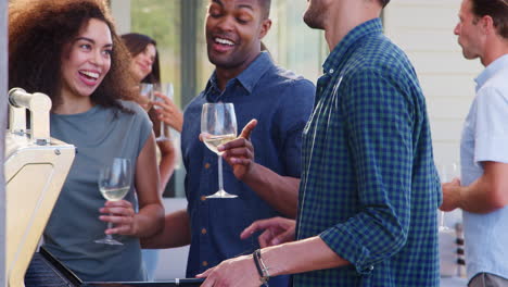 grupo de amigos disfrutando de una barbacoa en casa juntos