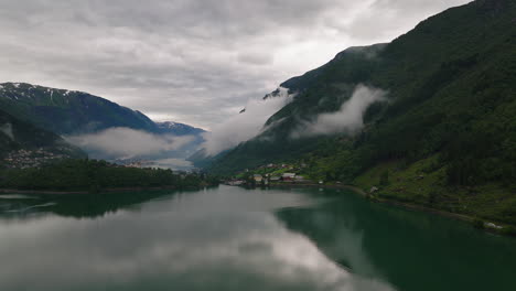 Aerial-dolly-to-low-misty-clouds-around-Odda-city-by-Sandvatnet-Lake