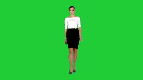 woman showing and presenting copy space in business dress on a green screen, chroma key