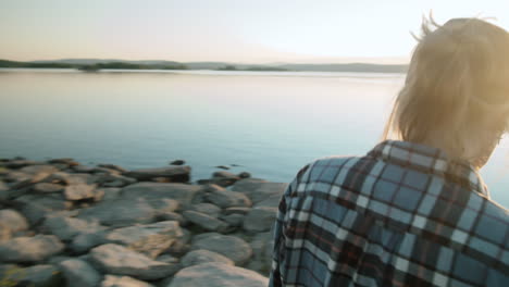 Female-Tourist-Walking-and-Enjoying-Sunset-over-Lake