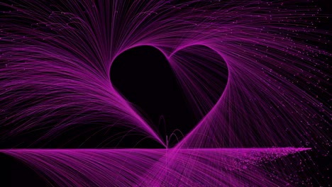 pink particles trace out a love heart on a black background - can be looped, copy space for your message