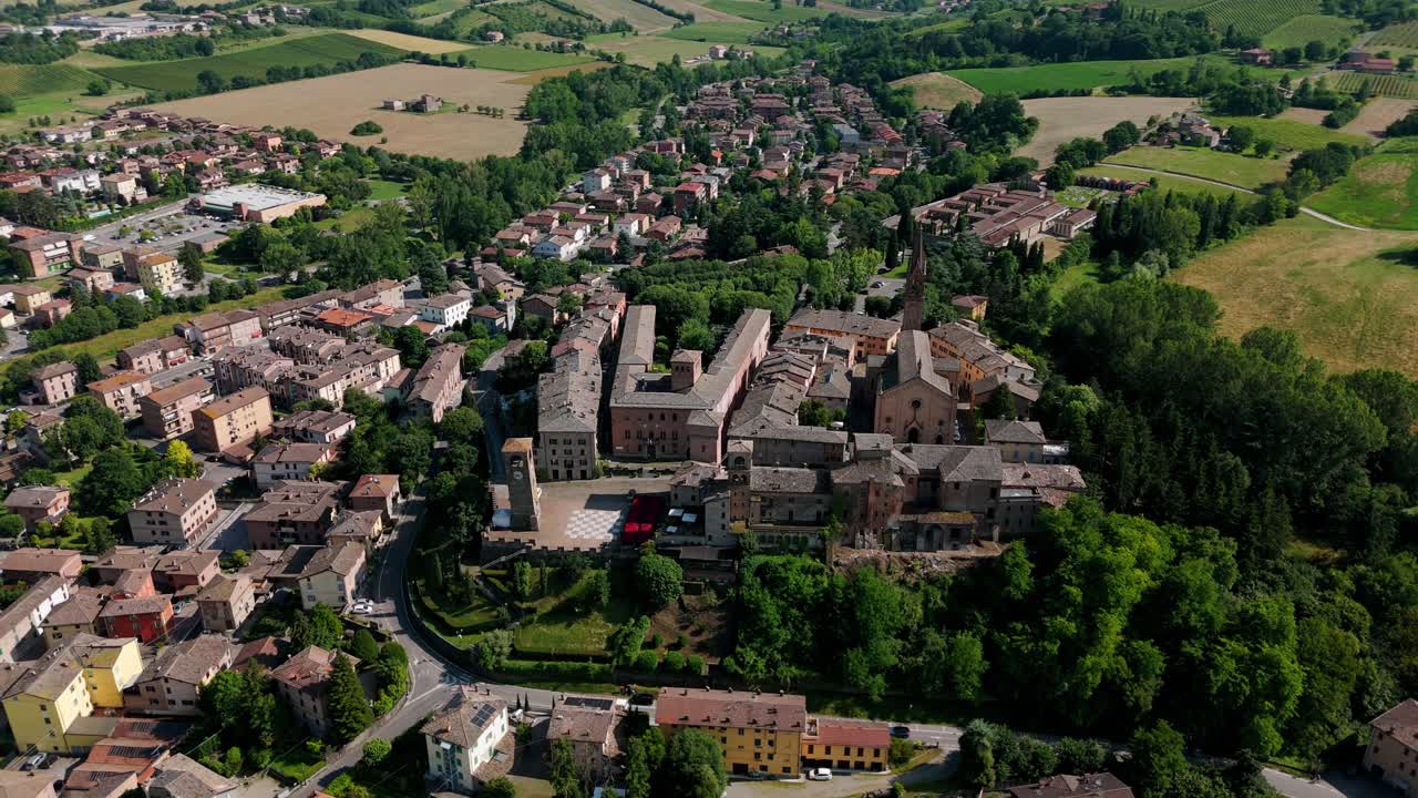 Aerial view of the historic Church of Saints Senesio and Teopompo nestled within the charming landscape of Modena, Italy. Circle Dolly