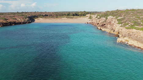 Flying-Over-Clear-Blue-Sea-In-Summer-Near-The-Calamosche-Beach-In-Sicily,-Italy