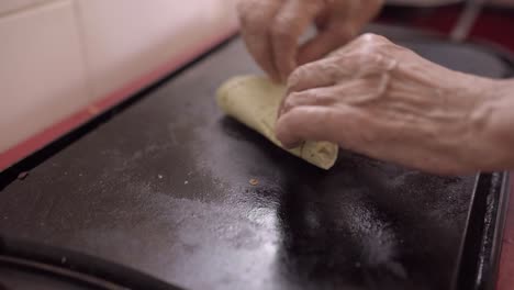 crop woman preparing tortilla with cheese at home