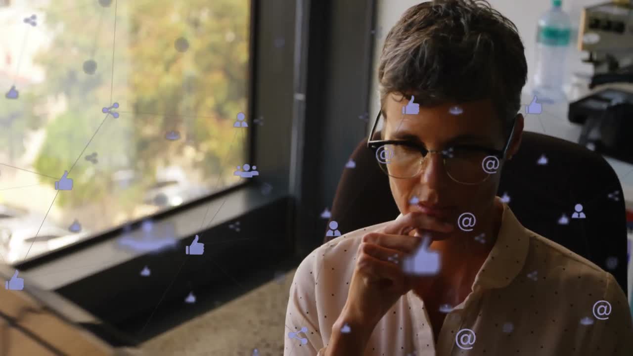 Animation of connections with icons over caucasian businesswoman in office