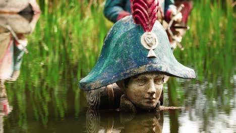 statues of napoleon warriors in deep water, close up view