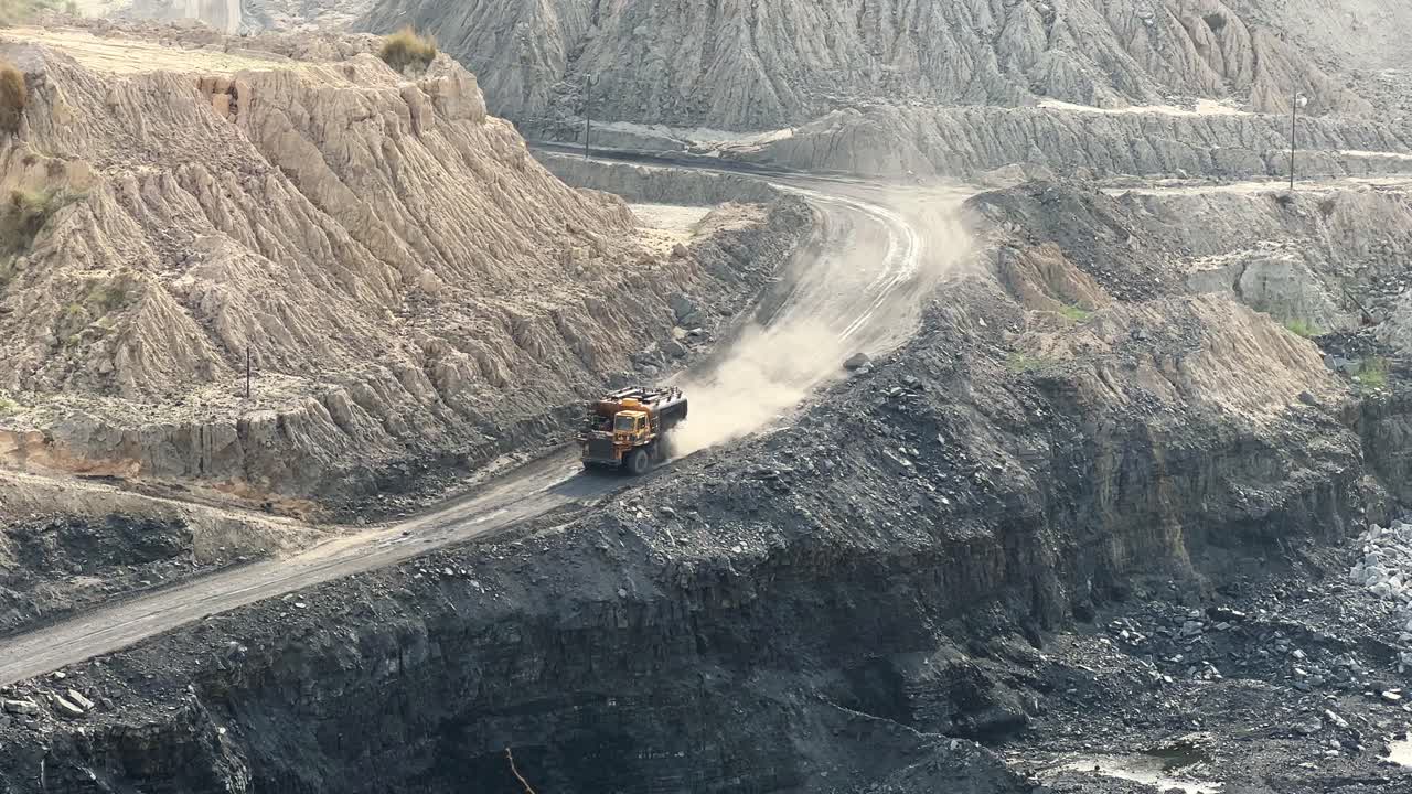 Large mining dump trucks, also known as haul truck going into the coal mine in india