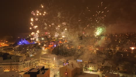 big bangs of colored fireworks that explode during new year's eve above akureyri in iceland