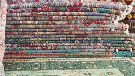 colorful rugs stacked in a shop