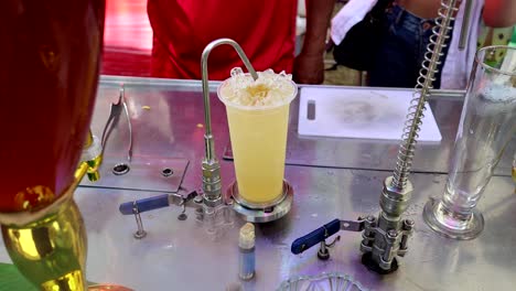 person preparing a drink with a special apparatus