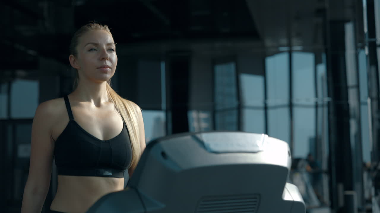 Woman Working Out on a Treadmill in a Modern Gym