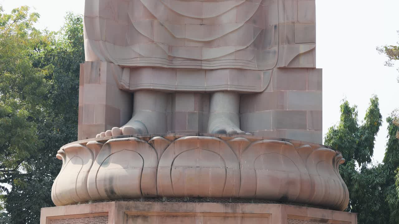 foot view of historic giant buddha carved in stone at outdoor