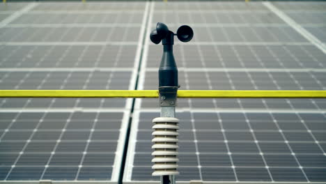 weather station for measuring wind velocity background solar cells. alternative source of electricity. solar farm.