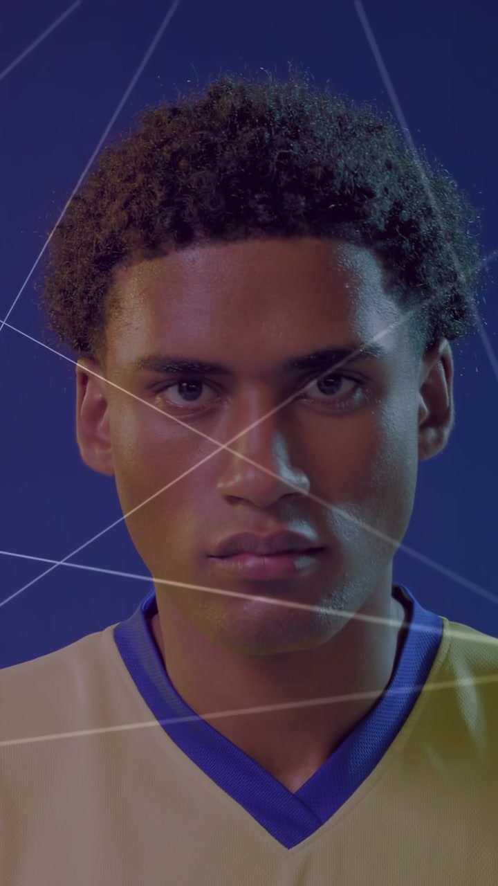 Vertical video: Hand showing soccer ball, man adjusting grip, lifting gaze for sport, glow on him