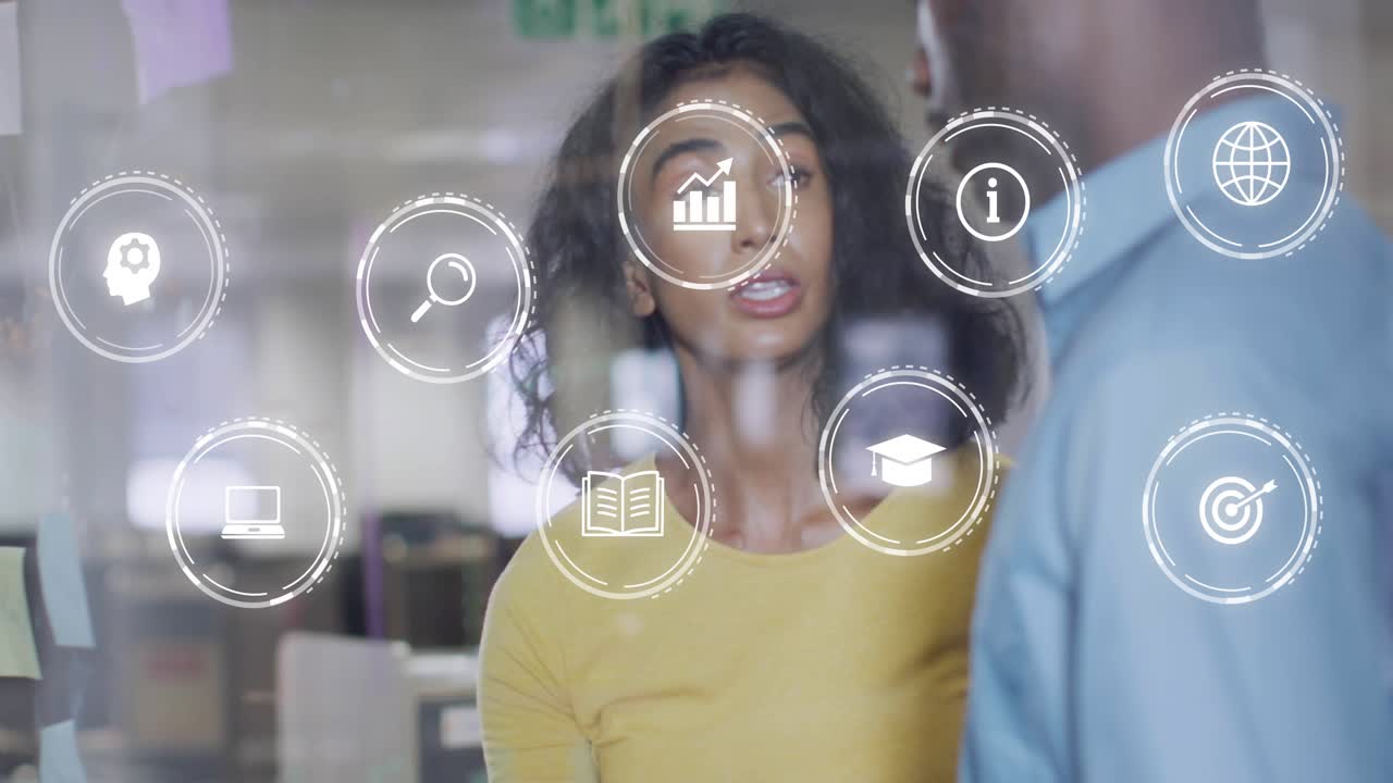 Woman holding tablet and pointing at notes, coworker watching HUD icons animating for business plan
