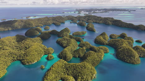 aerial cinematic sequence showcasing and revealing the serene turquoise coastline and small tropical islands around palau. wide revealing drone shot