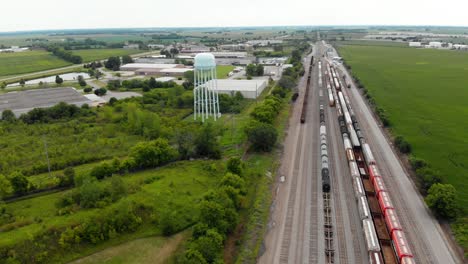 4k aerial view showing multiple trains parked at a train station waiting to leave