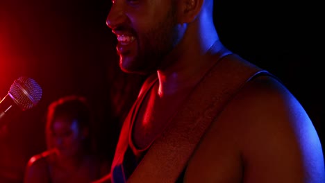 man singing song while playing electric guitar 4k