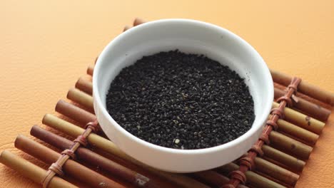 black sesame seeds in a small white bowl