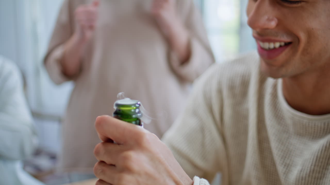 Man hands opening champagne bottle at home party closeup. Friends rejoicing
