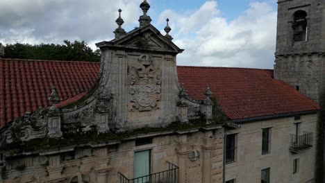 Crest-Above-Balcony-Surrounded-By-Moss-In-Santo-Estevo-Monastery,-Spain