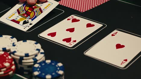 hands managing poker chips on green table, reflecting intense poker gameplay with the element of chance and skill