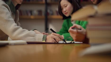 students collaborating on a project in a library