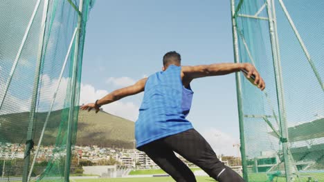 Mixed-race-athlete-doing-discus-throw