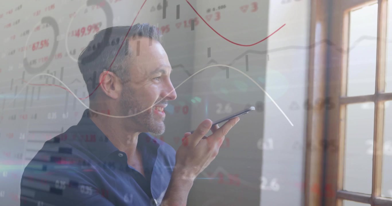 Businessman lifting smartphone to mouth speaking while floating charts showing financial update