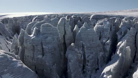 Aerial-tilt-up-reveal-shot-of-the-ice-of-the-Buerbreen-Glacier-in-Folgefonna,-Norway