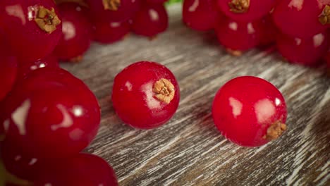 super close macro of a redcurrants on a wooden table.